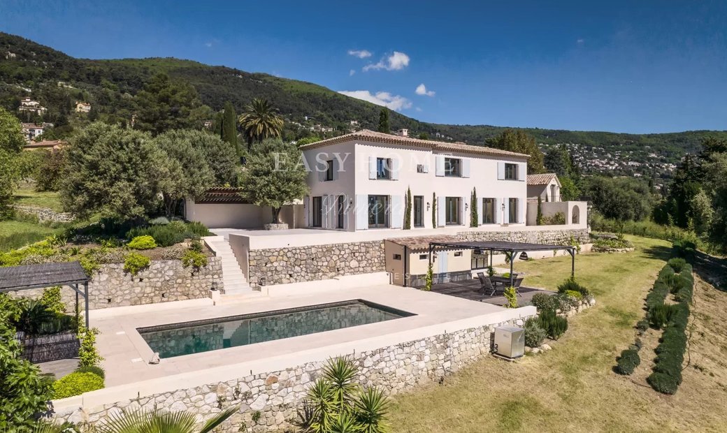 A house for sale in Grasse, with a stunning view of the surrounding landscape