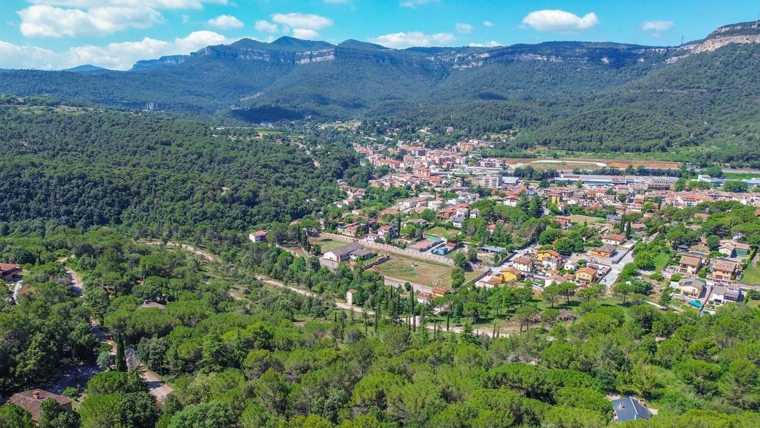 Catalonia’s Crown: A Visionary Canvas Above Aiguafreda’s Verdant Hills