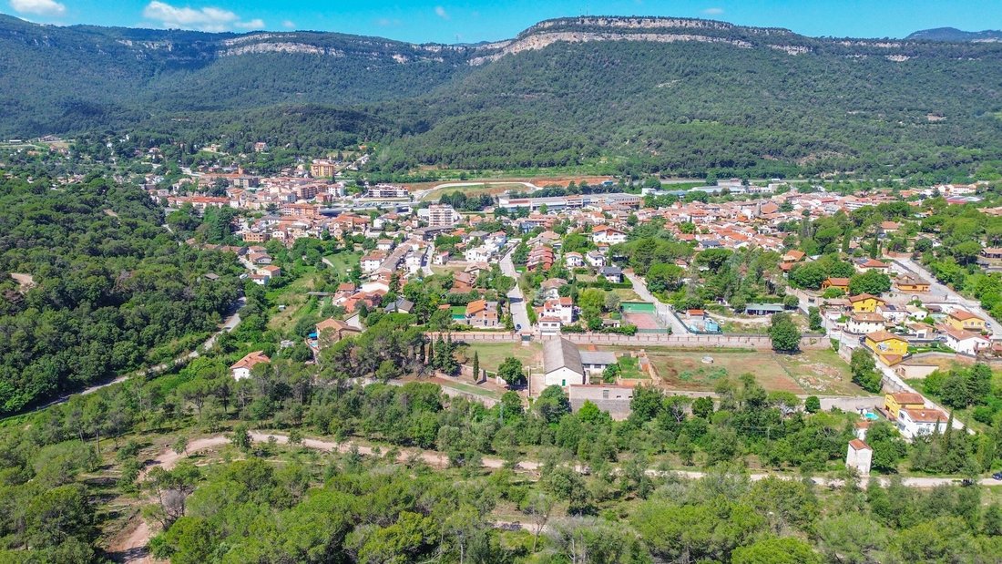 Catalonia’s Crown: A Visionary Canvas Above Aiguafreda’s Verdant Hills
