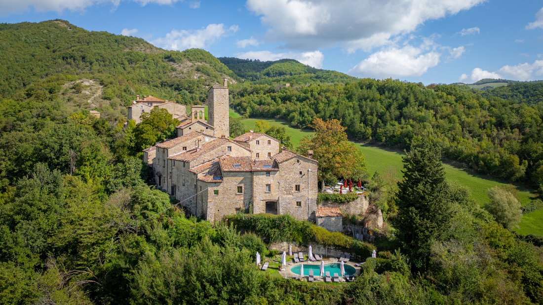 Whispers of the 12th Century: A Castle-Hamlet’s Timeless Embrace in Le Marche’s Emerald Hills