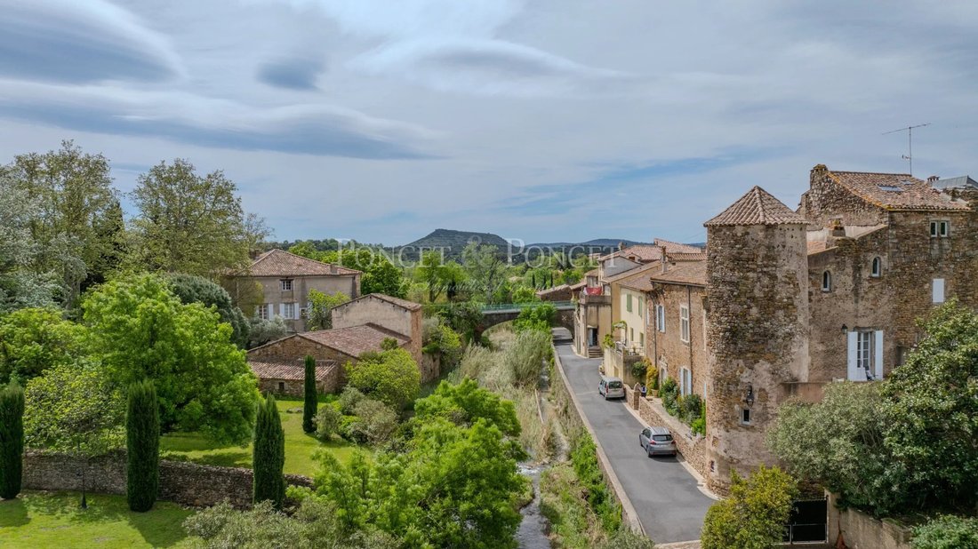 Whispers of the 13th Century: A Restored Château by Salagou’s Emerald Waters