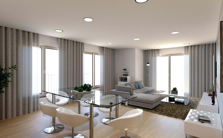 The bright and modern interior of a newly built apartment in Montijo, featuring an open-plan living space and high-quality finishes.